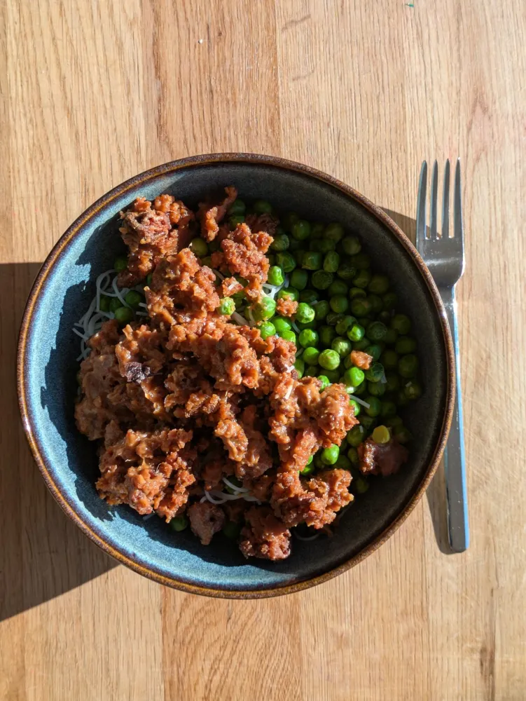 Vegan mince, peas and rice noodles, with peanut sauce.